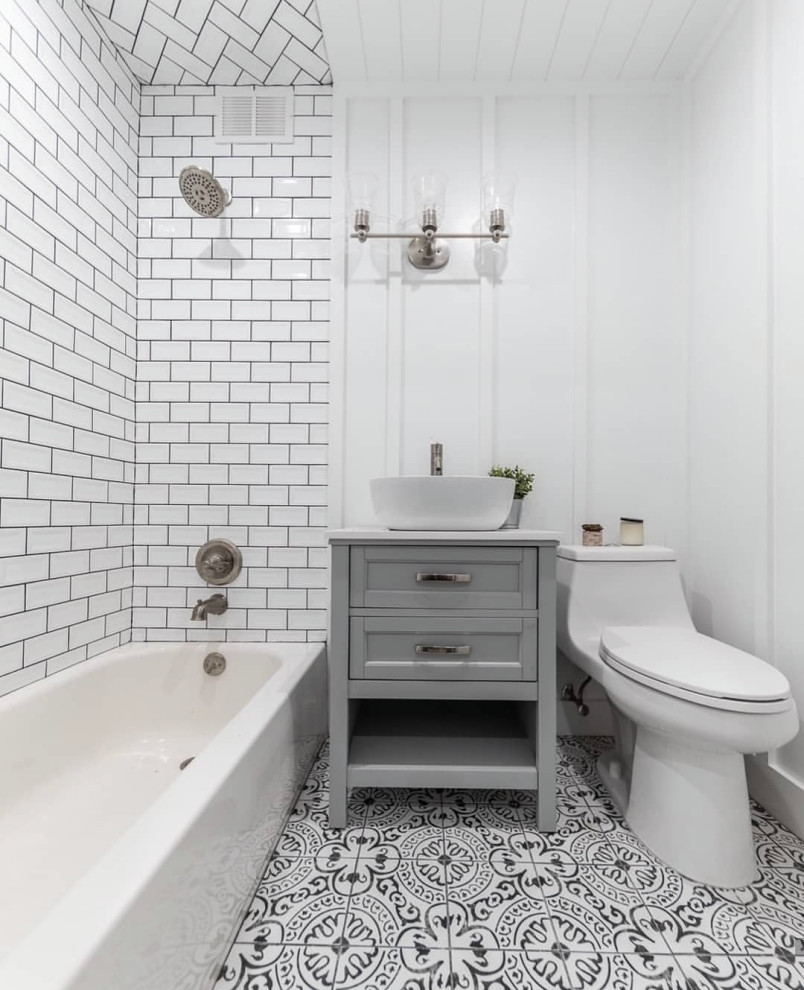 Design ideas for a mid-sized transitional 3/4 bathroom in Vancouver with recessed-panel cabinets, grey cabinets, an alcove tub, a shower/bathtub combo, a one-piece toilet, white tile, subway tile, white walls, a vessel sink, multi-coloured floor, an open shower, grey benchtops, a single vanity and a built-in vanity.