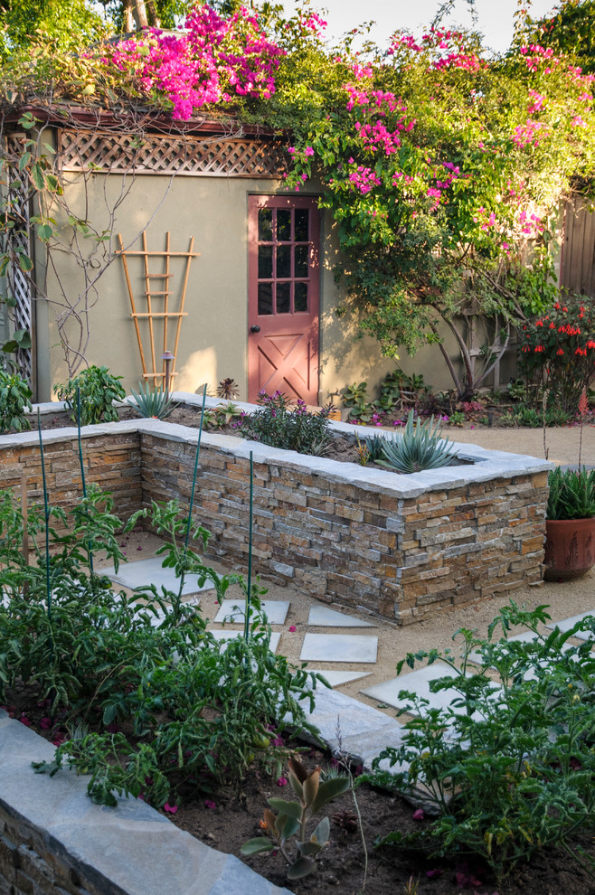 This is an example of a mid-sized traditional backyard partial sun formal garden in Los Angeles with a vegetable garden and gravel.