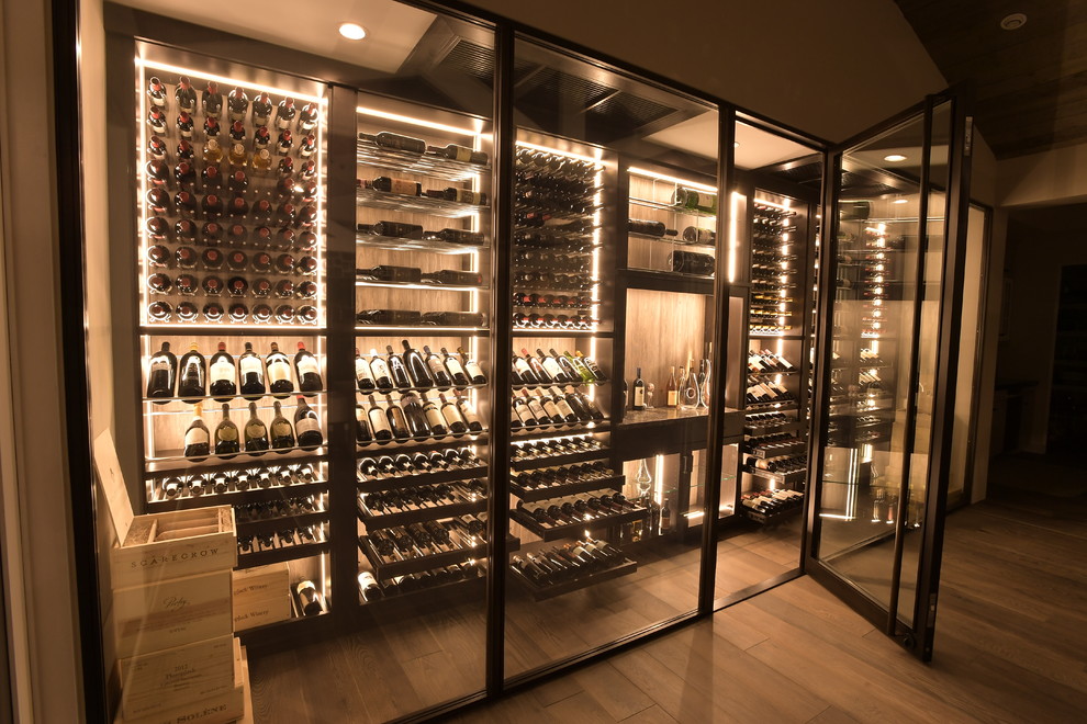 Example of a large trendy medium tone wood floor wine cellar design in Orange County