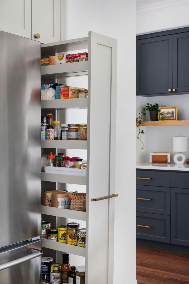 Example of a mid-sized transitional medium tone wood floor and brown floor kitchen design in Austin with an undermount sink, shaker cabinets, gray cabinets, quartz countertops, white backsplash, brick backsplash and white countertops