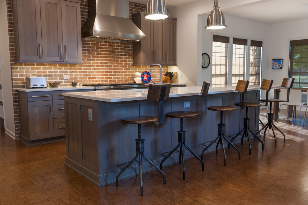 Inspiration for a large kitchen in Philadelphia with quartz benchtops, stainless steel appliances, cork floors, with island, an undermount sink, grey cabinets, brick splashback and brown floor.