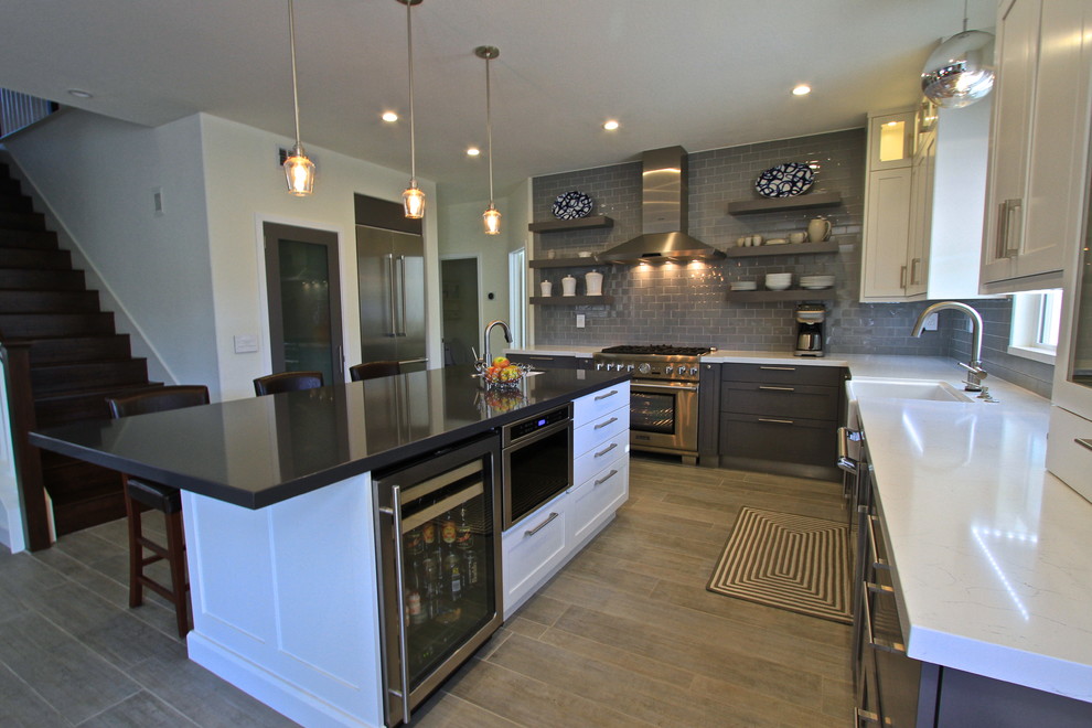 Transitional porcelain tile kitchen photo in Orange County with glass tile backsplash and an island