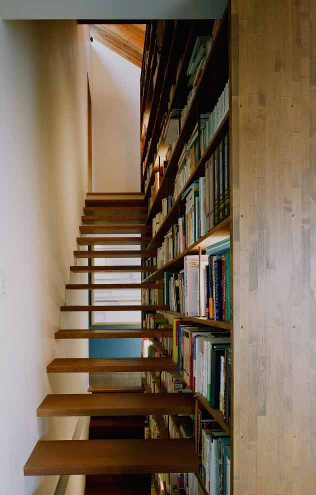 Mid-sized modern wood straight staircase in Kobe with open risers.