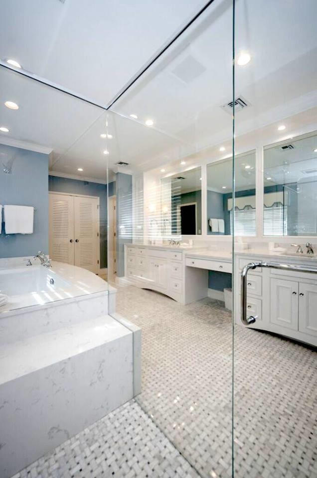 Large contemporary master bathroom in Tampa with raised-panel cabinets, white cabinets, a corner tub, black and white tile, ceramic tile, blue walls, ceramic floors and marble benchtops.