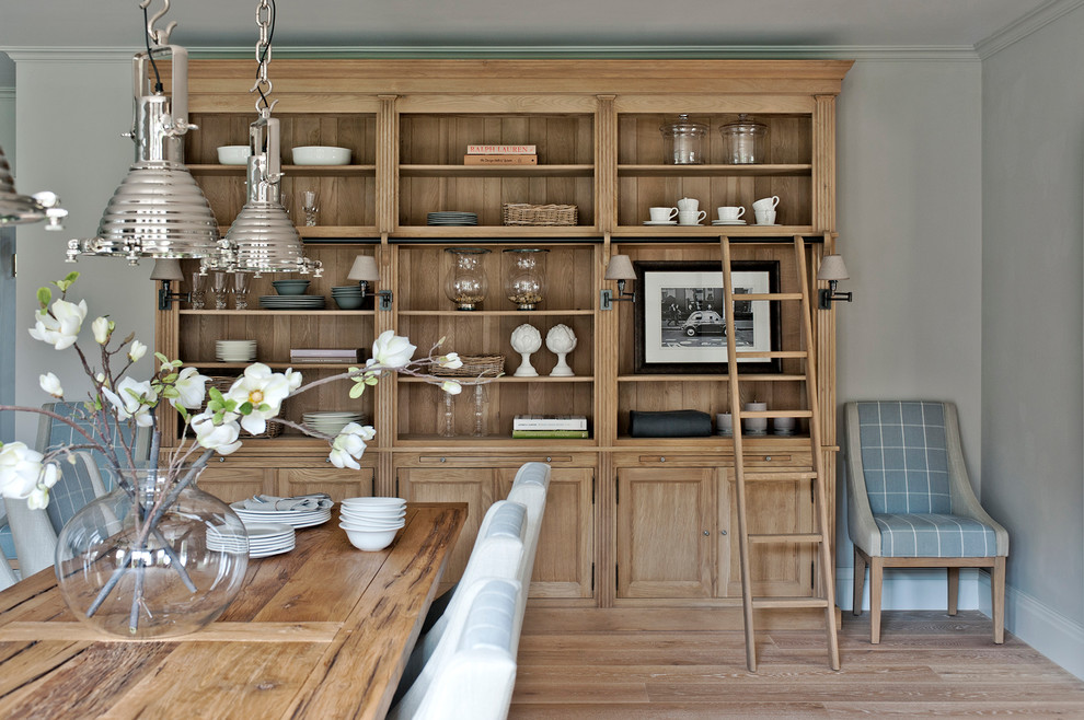 Design ideas for a large contemporary kitchen/dining combo in Gloucestershire with medium hardwood floors.