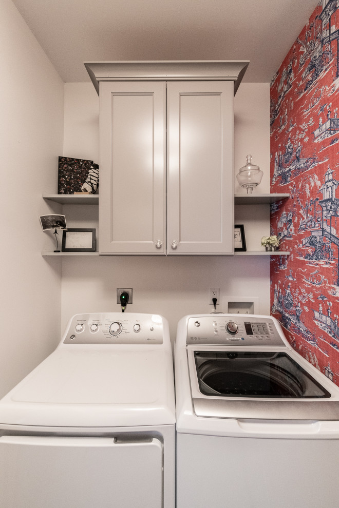 Mid-sized traditional u-shaped dedicated laundry room in Other with a drop-in sink, recessed-panel cabinets, beige cabinets, laminate benchtops, red walls, porcelain floors, a side-by-side washer and dryer, beige floor and beige benchtop.