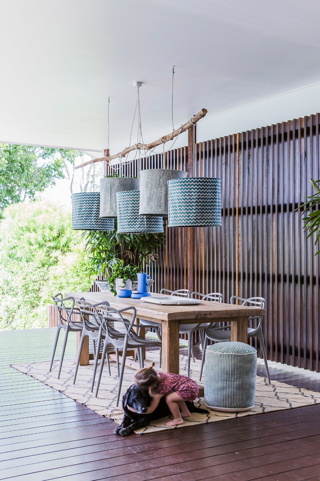 Design ideas for a mid-sized contemporary deck in Sydney with a roof extension.