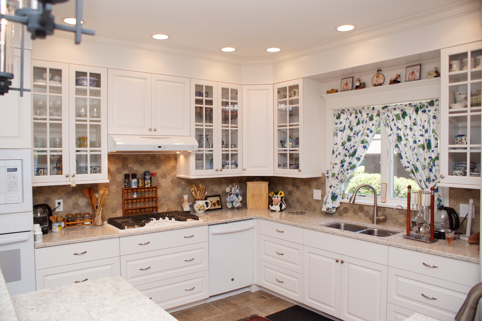 Eat-in kitchen - mid-sized transitional u-shaped porcelain tile eat-in kitchen idea with an undermount sink, flat-panel cabinets, white cabinets, granite countertops, stone tile backsplash, stainless steel appliances, a peninsula and multicolored backsplash