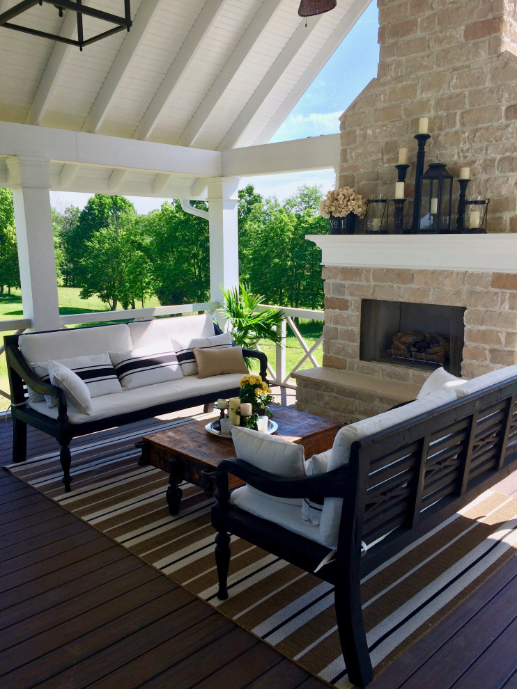 Inspiration for a medium sized classic back mixed railing veranda in Cincinnati with a fireplace, decking and a roof extension.