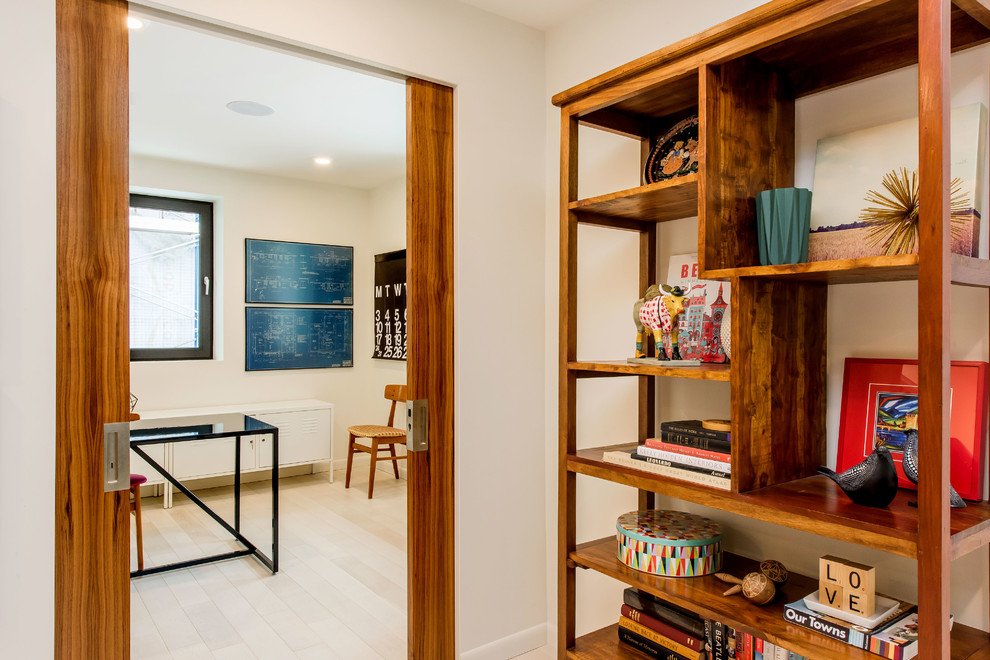 Mid-sized mid-century modern freestanding desk light wood floor home office photo in Other with white walls