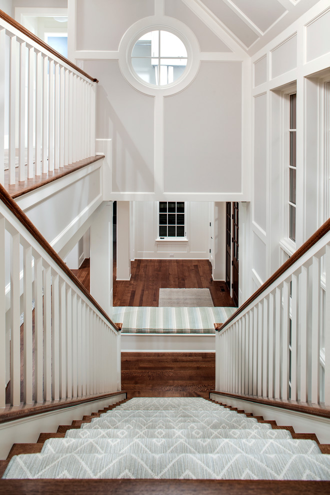 Photo of a traditional carpeted staircase in Minneapolis with carpet risers.