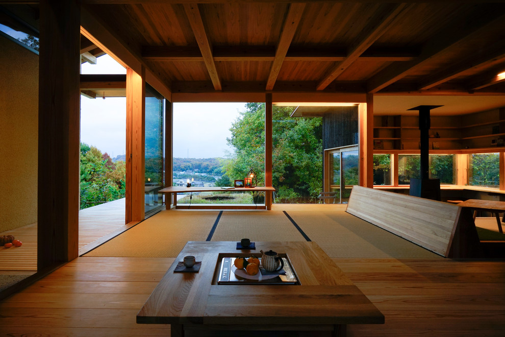 Design ideas for an asian open concept family room in Kobe with tatami floors, a wood stove and brown floor.