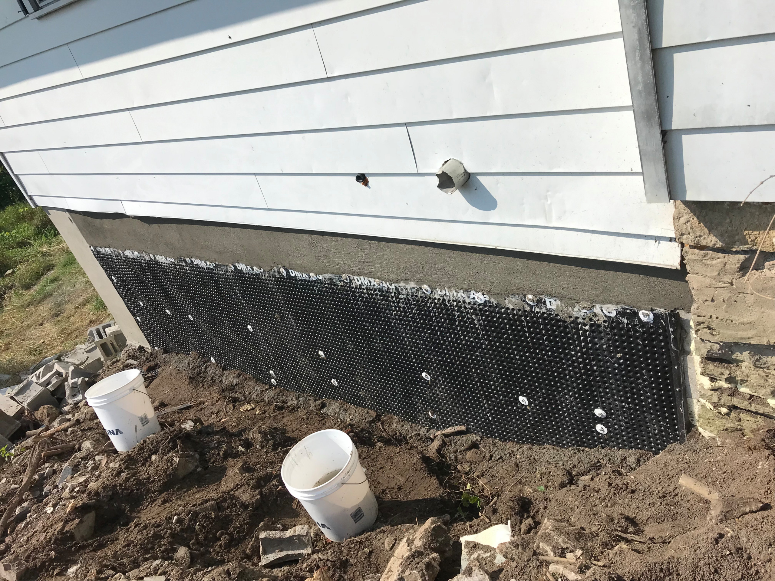 We then waterproofed, backfilled and properly sloped the area for drainage."