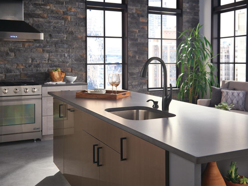 Inspiration for a large modern kitchen in Indianapolis with a single-bowl sink, flat-panel cabinets, concrete benchtops, stone tile splashback, stainless steel appliances, concrete floors, with island, grey floor and grey benchtop.