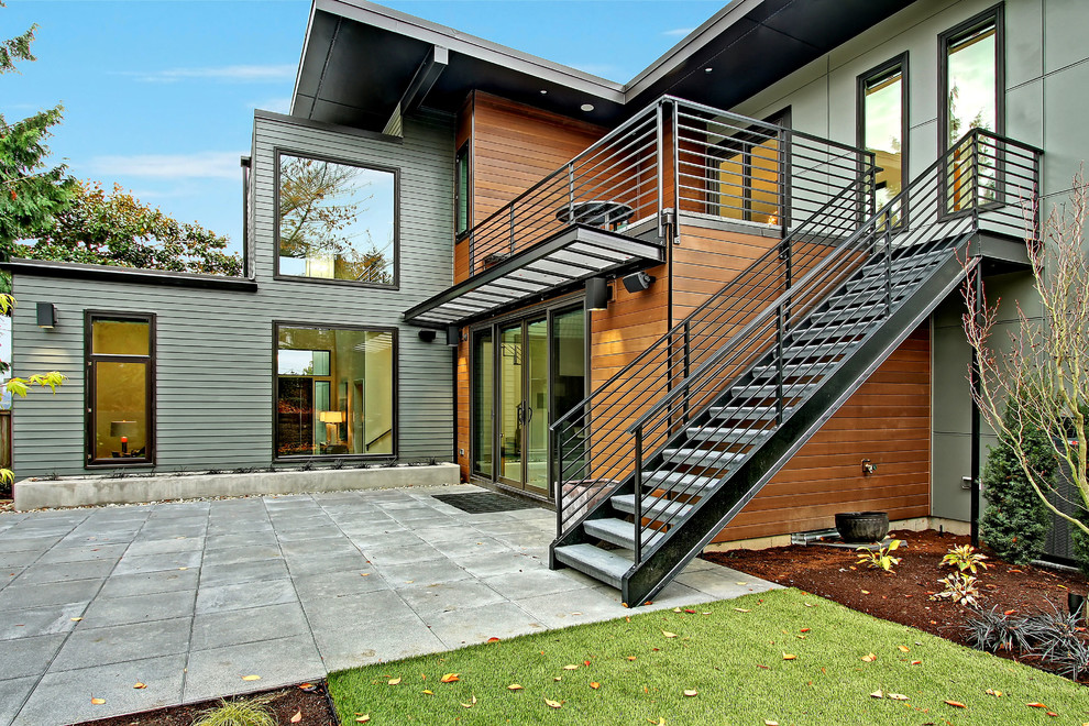 Design ideas for a contemporary backyard patio in Seattle with concrete pavers and an awning.