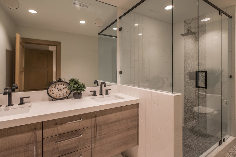 Inspiration for a large contemporary master bathroom in Salt Lake City with flat-panel cabinets, medium wood cabinets, a corner shower, white tile, ceramic tile, white walls, porcelain floors, an undermount sink, engineered quartz benchtops, beige floor, a hinged shower door and white benchtops.