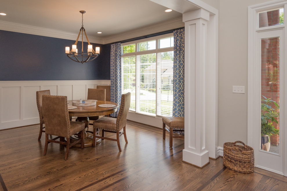 Mid-sized traditional separate dining room in Louisville with blue walls, dark hardwood floors and brown floor.