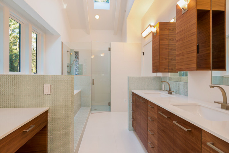 Inspiration for a large transitional master green tile white floor drop-in bathtub remodel in Denver with flat-panel cabinets, medium tone wood cabinets, white walls, an undermount sink and a hinged shower door