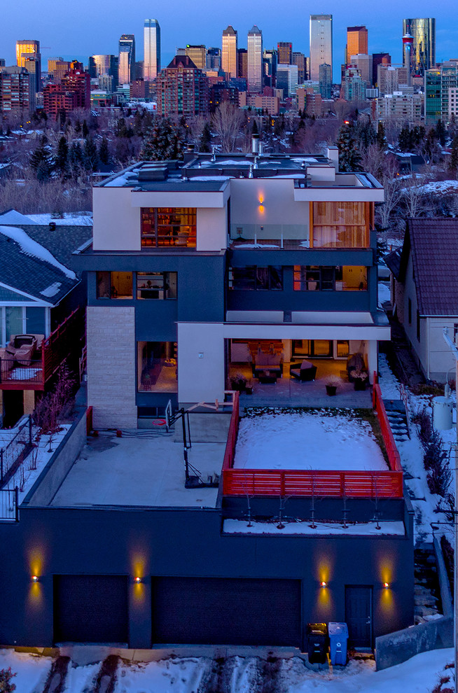 Photo of a large contemporary three-storey stucco multi-coloured exterior in Calgary with a flat roof.
