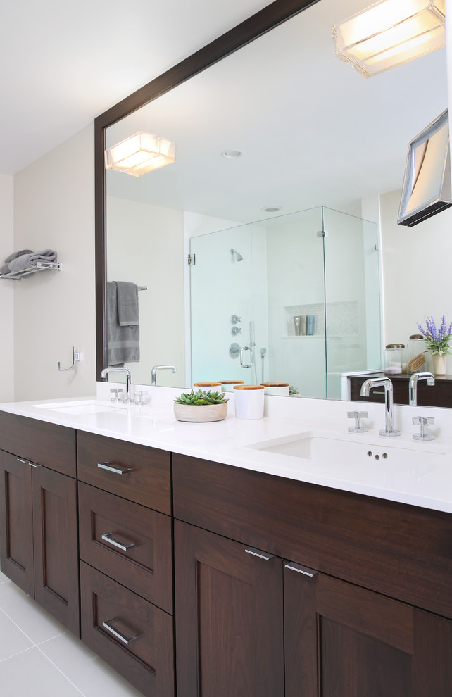 This is an example of a small modern master bathroom in Chicago with recessed-panel cabinets, medium wood cabinets, a corner shower, white tile, porcelain tile, beige walls, porcelain floors, an undermount sink and engineered quartz benchtops.