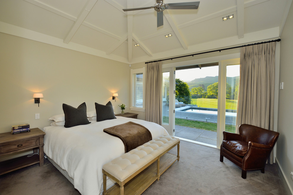 Photo of a country guest bedroom in Napier-Hastings with beige walls and carpet.