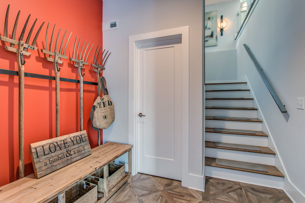 Inspiration for a country mudroom in Orange County with grey walls, medium hardwood floors and brown floor.