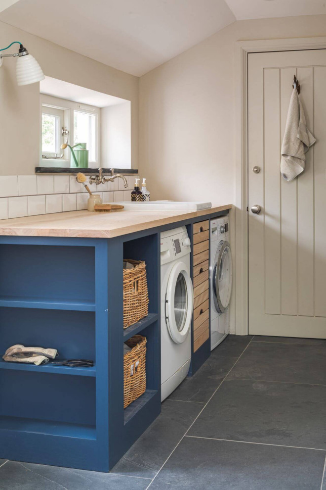 Design ideas for a large country l-shaped laundry room in Other with shaker cabinets and blue cabinets.