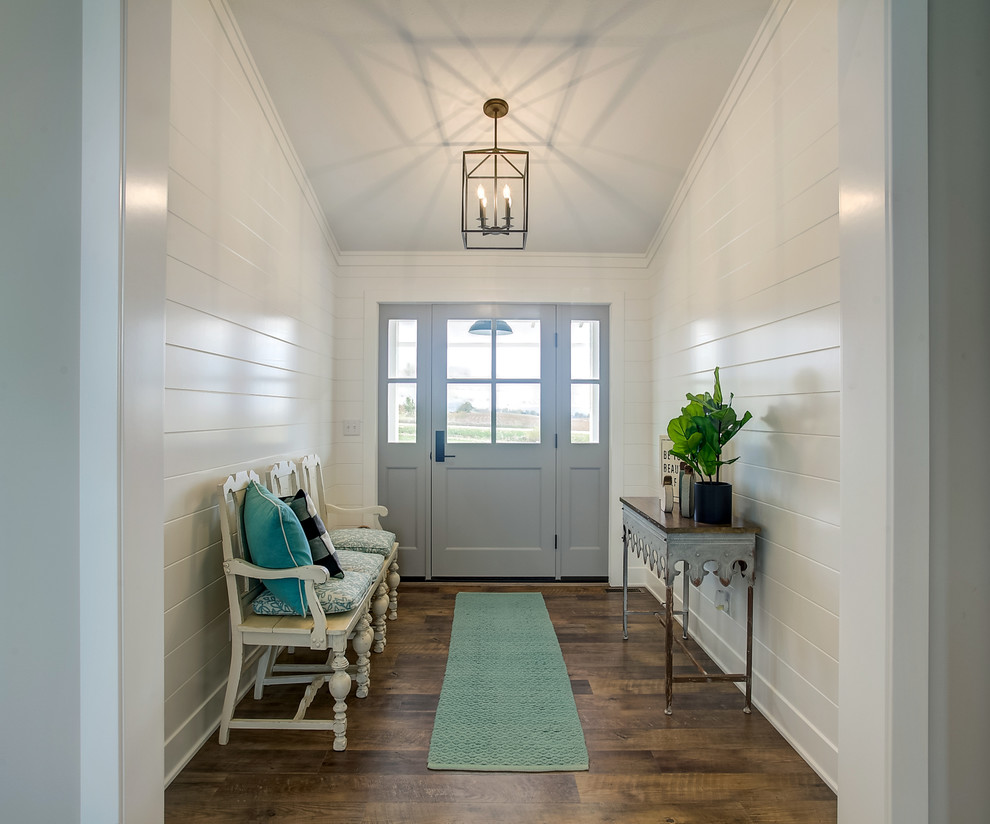 Inspiration for a country entry hall in Grand Rapids with white walls, medium hardwood floors, a single front door, a gray front door and brown floor.
