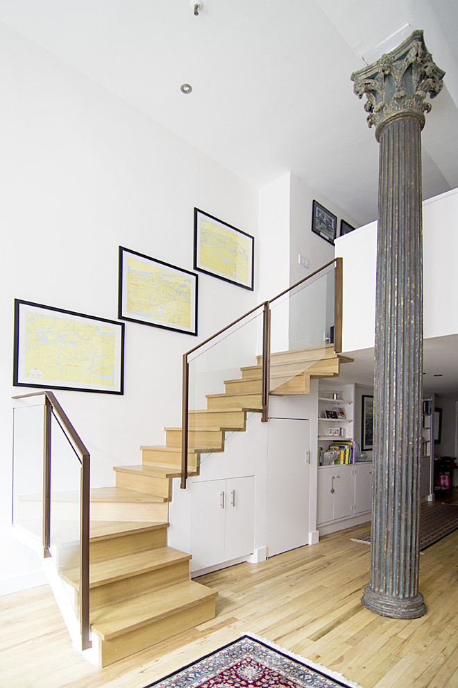 Design ideas for a mid-sized contemporary wood l-shaped staircase in New York with wood risers and glass railing.