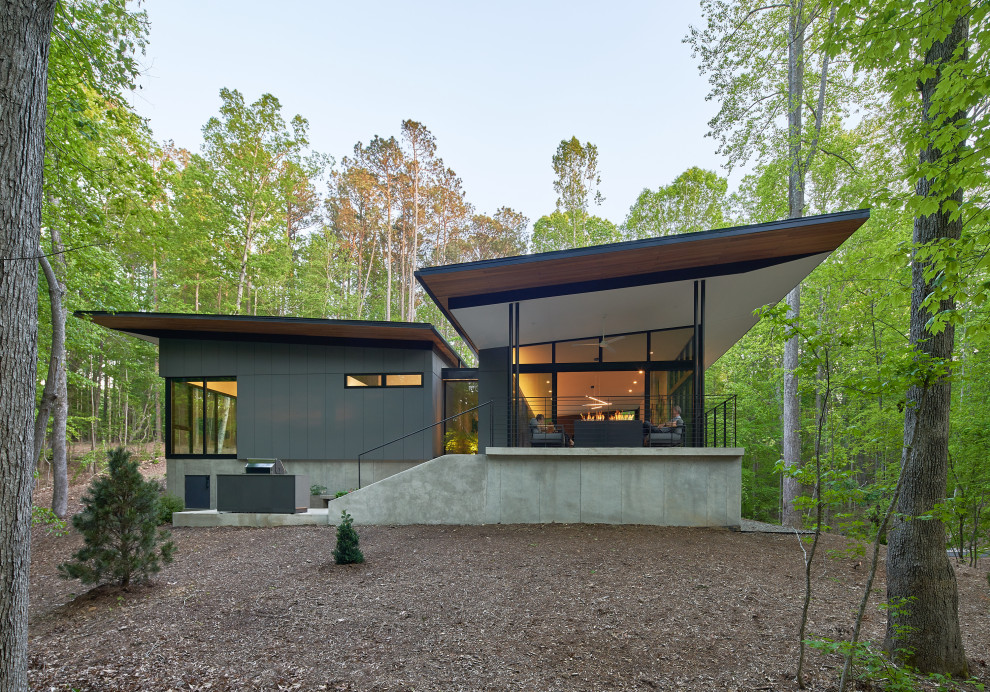 Modern one-storey grey house exterior in Raleigh with a butterfly roof.