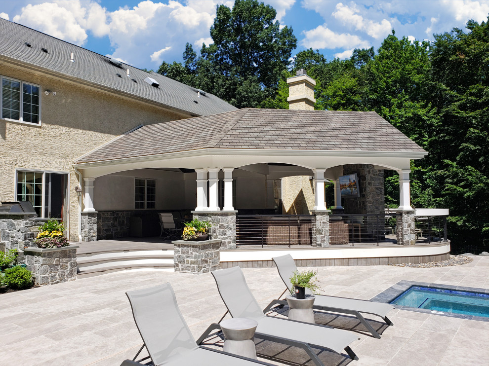 Transitional metal railing back porch photo with a fireplace