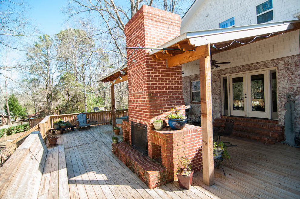 This is an example of a mid-sized arts and crafts backyard deck in Atlanta with an awning.