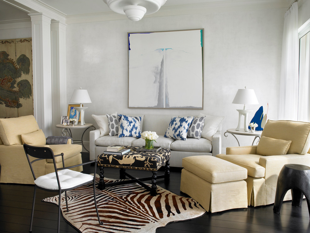 This is an example of a transitional living room in Miami with white walls and dark hardwood floors.