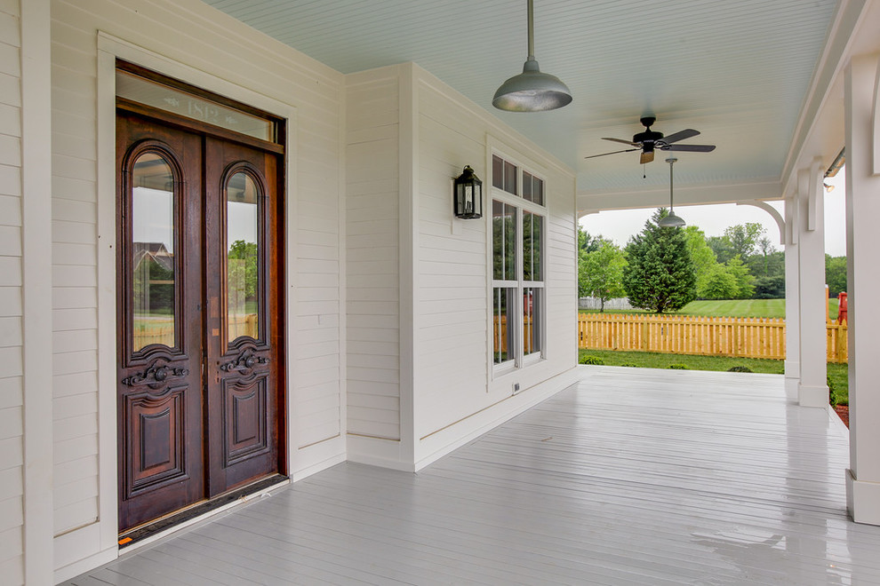Inspiration for a large cottage white two-story vinyl gable roof remodel in Nashville