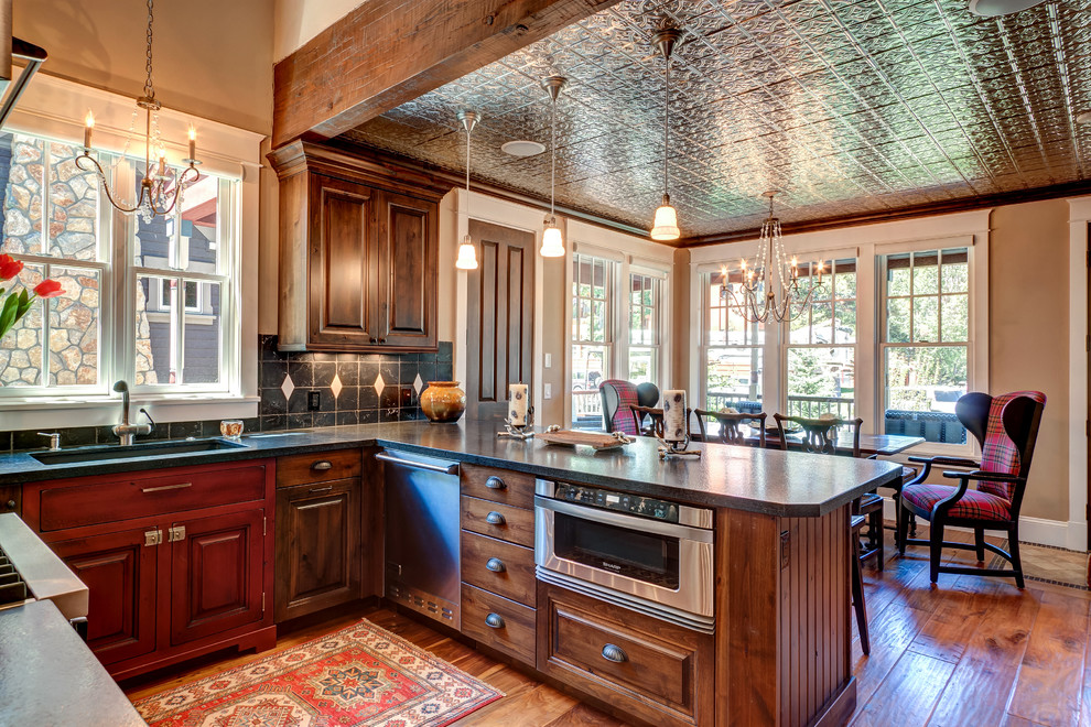 Inspiration for a mid-sized traditional u-shaped eat-in kitchen in Denver with an undermount sink, raised-panel cabinets, medium wood cabinets, stainless steel appliances, medium hardwood floors and no island.