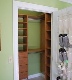 Photo of a small contemporary gender-neutral built-in wardrobe in Los Angeles with flat-panel cabinets and medium wood cabinets.