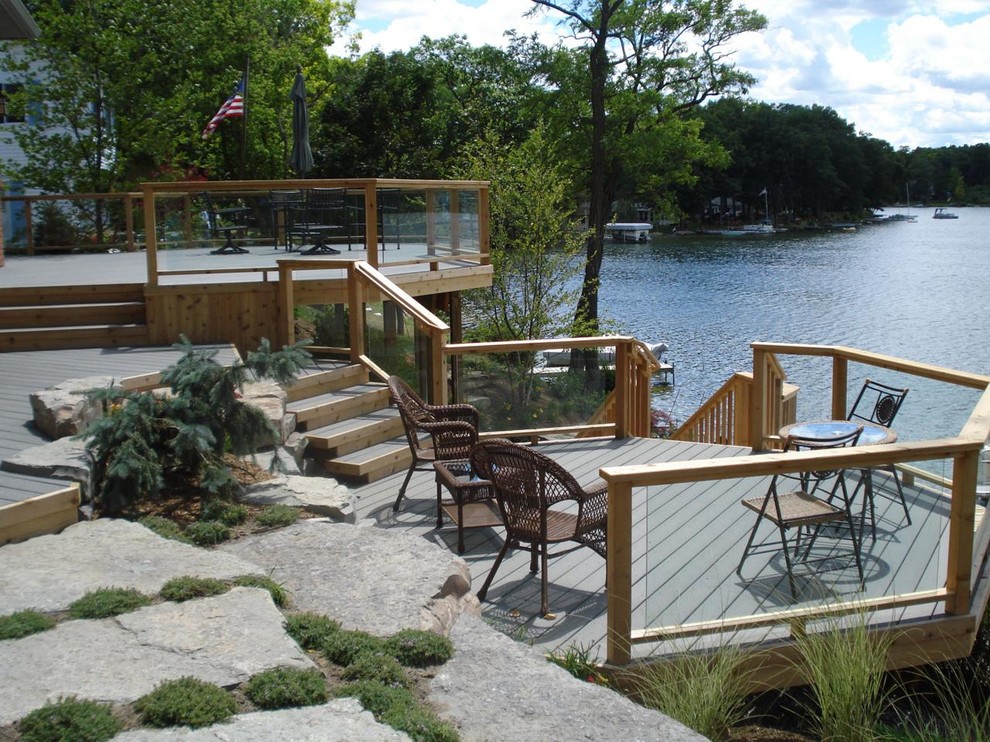 Inspiration for a large rustic backyard balcony deck remodel in Detroit with no cover