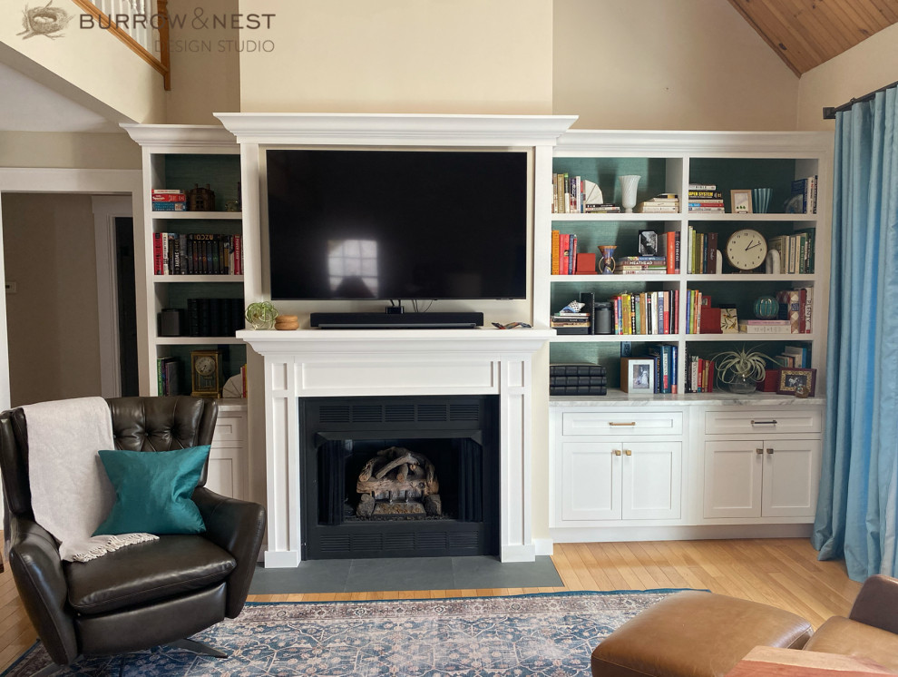 Inspiration for a rural living room in Providence with a wooden fireplace surround.