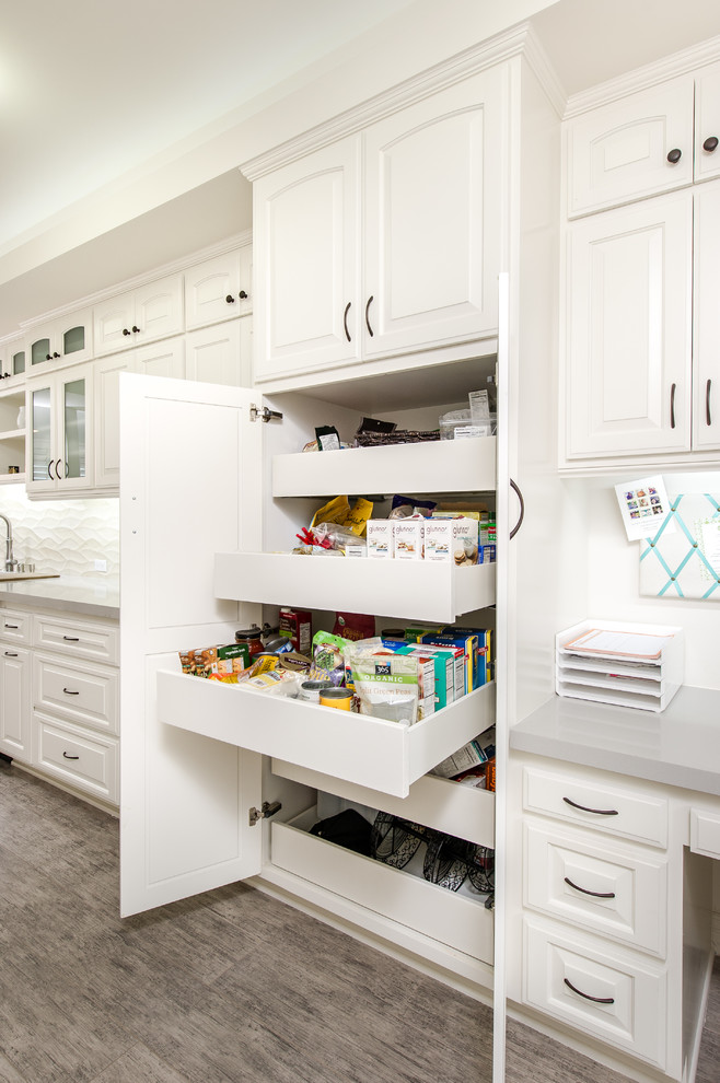 Inspiration for a small traditional kitchen pantry in Los Angeles with an undermount sink, white cabinets, quartz benchtops, beige splashback, ceramic splashback, stainless steel appliances, porcelain floors and raised-panel cabinets.