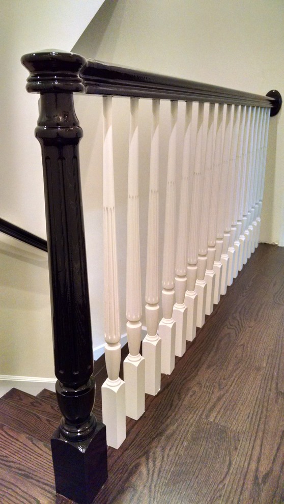 This is an example of a mid-sized transitional wood staircase in New York with wood risers and wood railing.