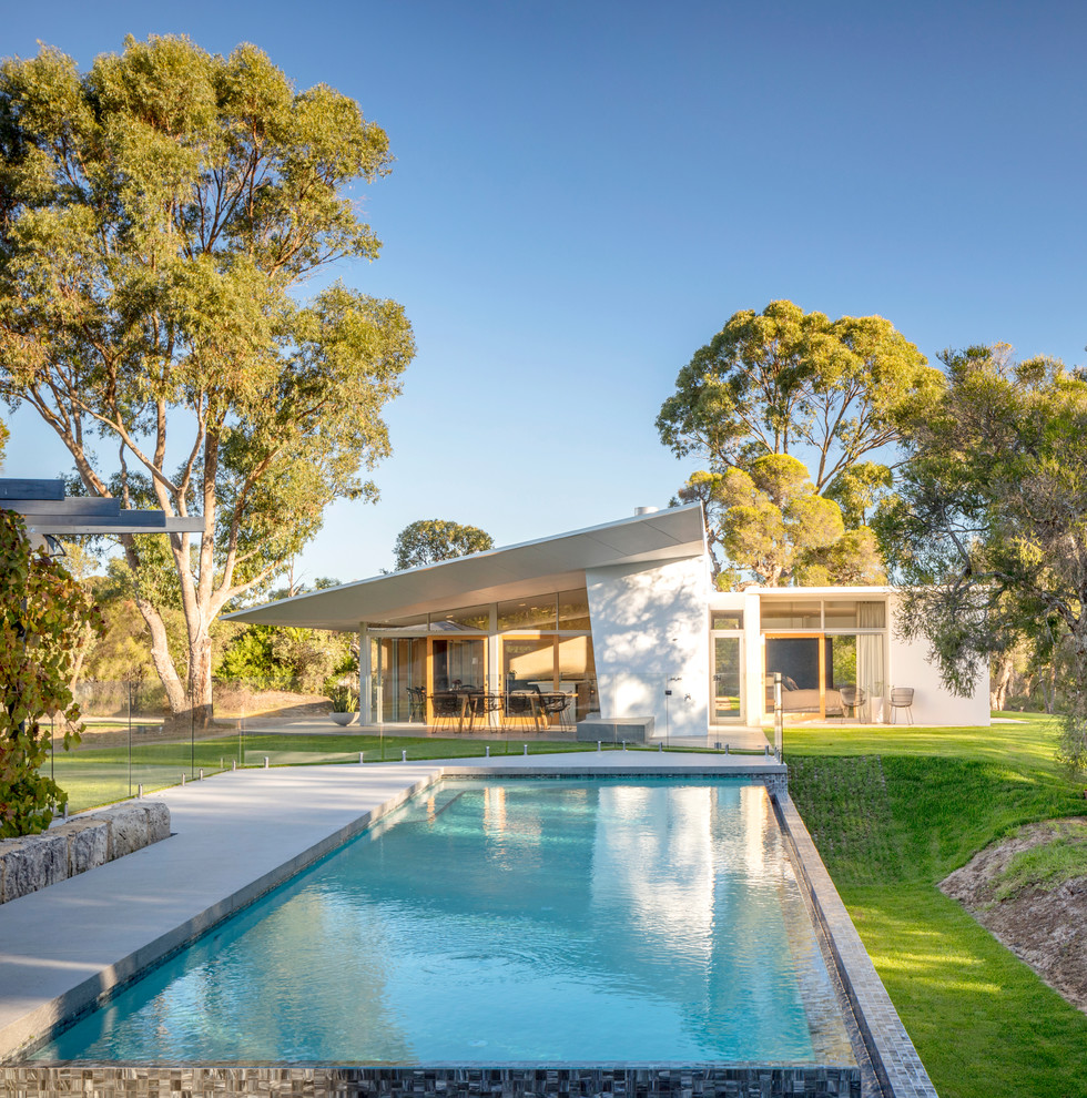 Photo of a midcentury backyard rectangular pool in Perth.