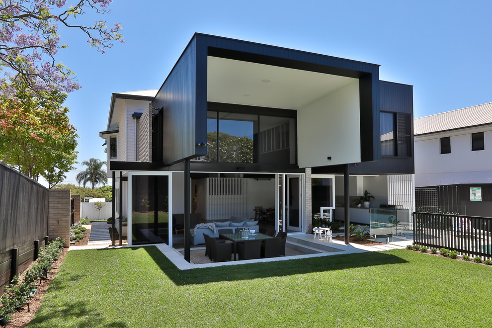 Contemporary two-storey black house exterior in Brisbane with mixed siding and a flat roof.