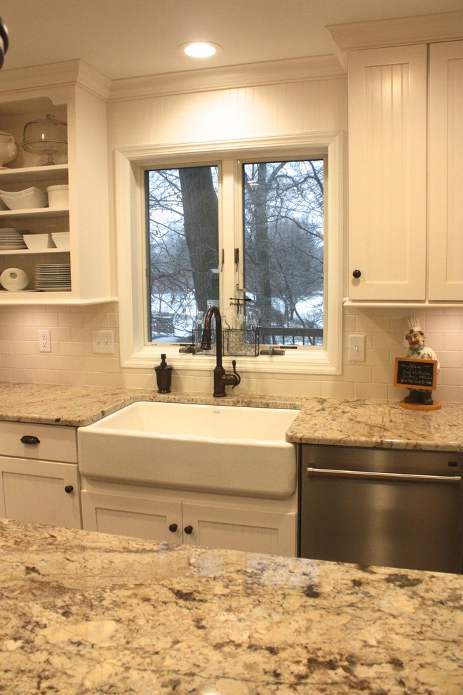 Large transitional u-shaped eat-in kitchen photo with shaker cabinets, white cabinets, white backsplash, stainless steel appliances and an island