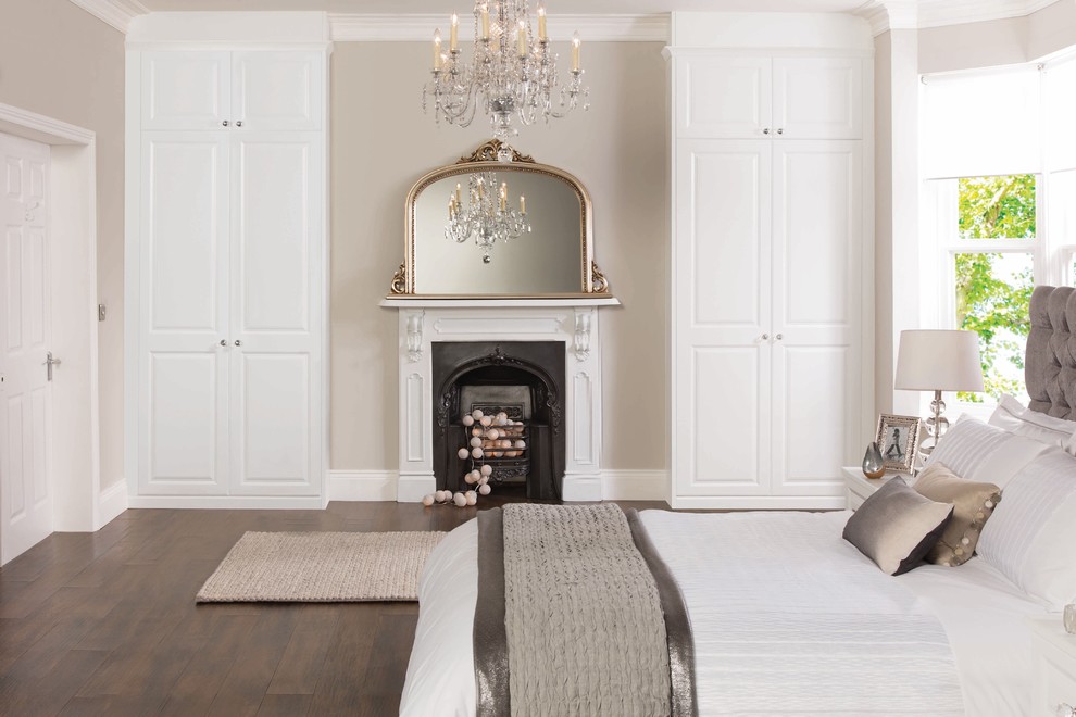Design ideas for a mid-sized transitional master bedroom in West Midlands with white walls, dark hardwood floors, a standard fireplace and a metal fireplace surround.