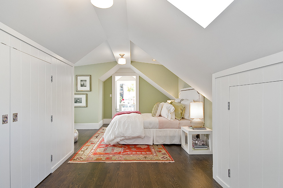 This is an example of a traditional bedroom in San Francisco with beige walls and dark hardwood floors.