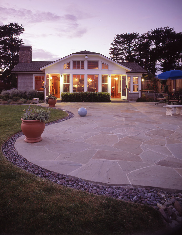 Photo of a large beach style backyard patio in San Francisco with natural stone pavers and no cover.