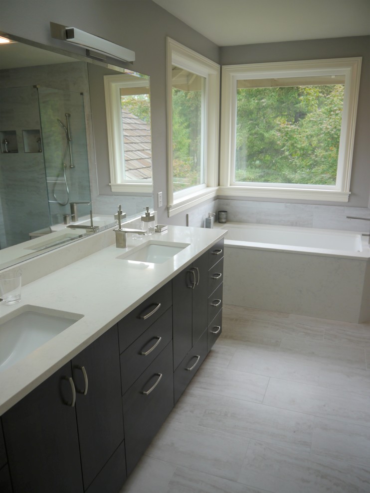 Photo of a mid-sized modern master bathroom in Seattle with flat-panel cabinets, grey cabinets, an undermount tub, a curbless shower, white tile, porcelain tile, grey walls, porcelain floors, an undermount sink, engineered quartz benchtops, white floor, a hinged shower door and white benchtops.