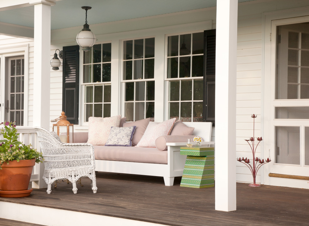Beach style porch idea in Denver with decking and a roof extension