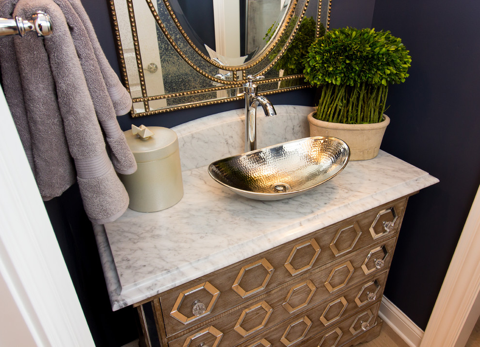 Inspiration for a small transitional powder room in Columbus with furniture-like cabinets, light wood cabinets, blue walls, light hardwood floors, a vessel sink, quartzite benchtops, brown floor and white benchtops.