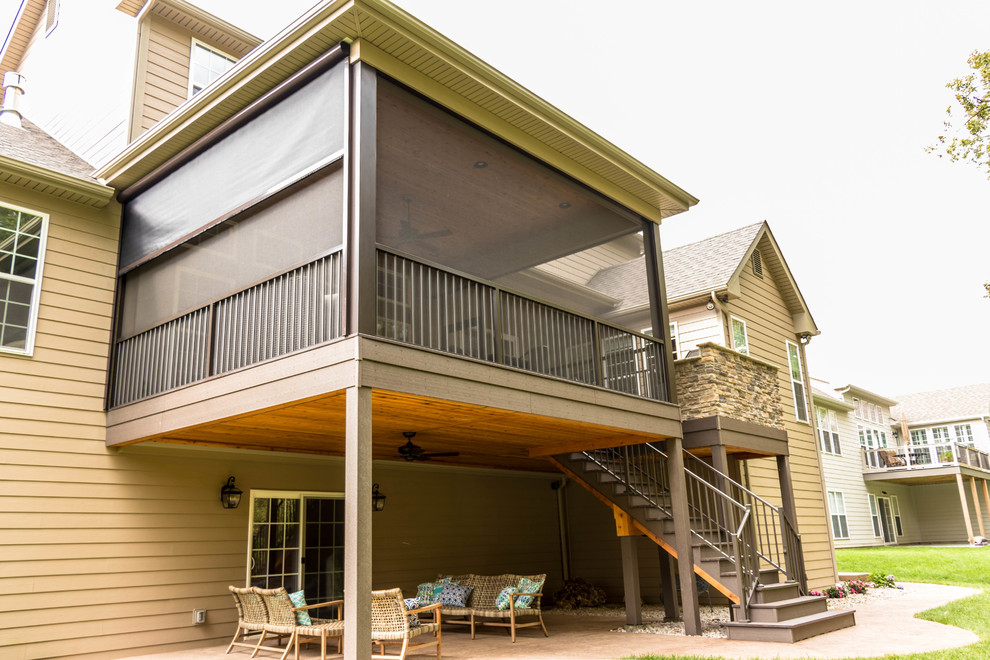 Mid-sized elegant screened-in back porch photo in St Louis with a roof extension